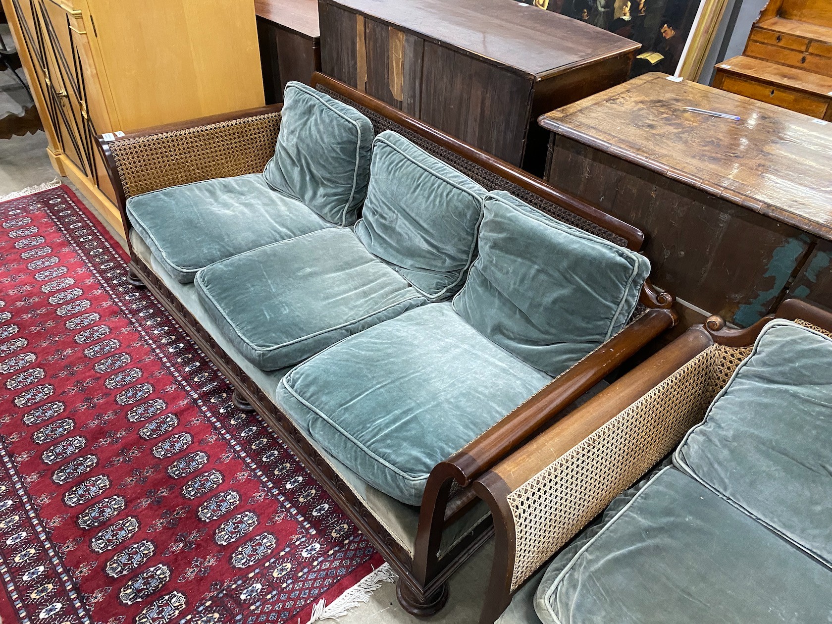 An early 20th century mahogany single caned three piece bergere suite, settee length 182cm, depth 77cm, height 68cm